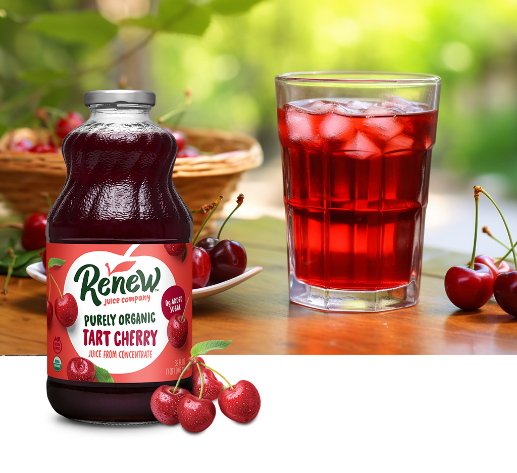 Bottle of Renew Purely Organic Tart Cherry Juice with a group of cherries in front and an image of a glass of cherry juice on a wood table outside.